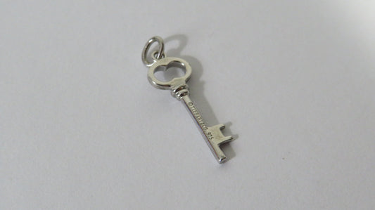 Silver key-shaped pendant on a white background