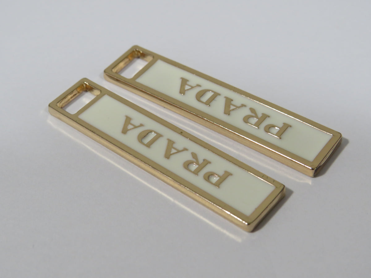 Bundle Of 2 Prada Gold And Cream Zipper Pulls!