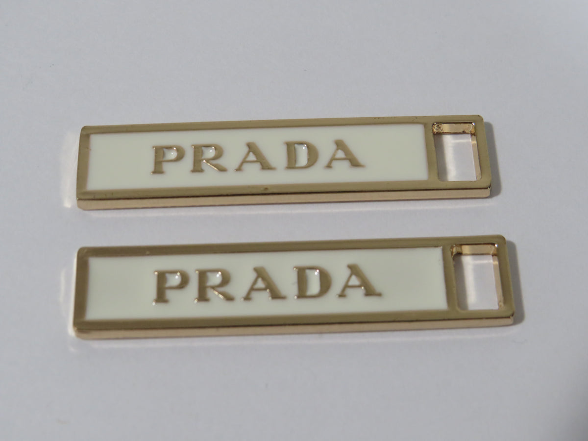 Bundle Of 2 Prada Gold And Cream Zipper Pulls!