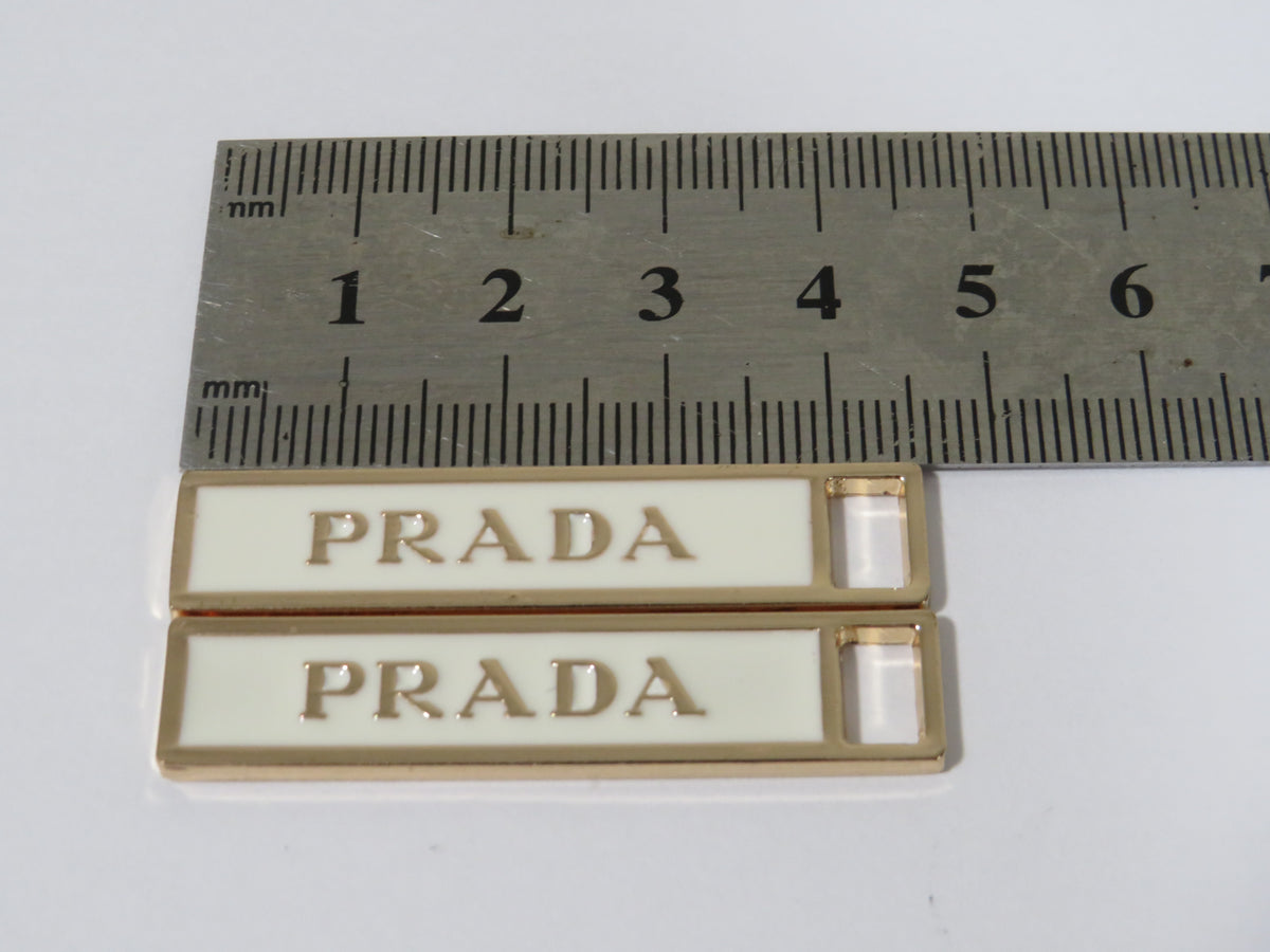 Bundle Of 2 Prada Gold And Cream Zipper Pulls!