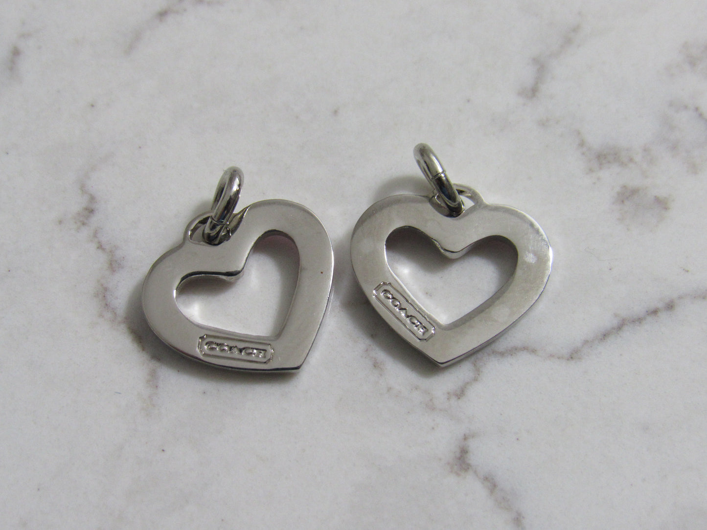 Bundle Of 2 Coach Silver And Pink Tone Hollow Mini Heart Charms Stamped!